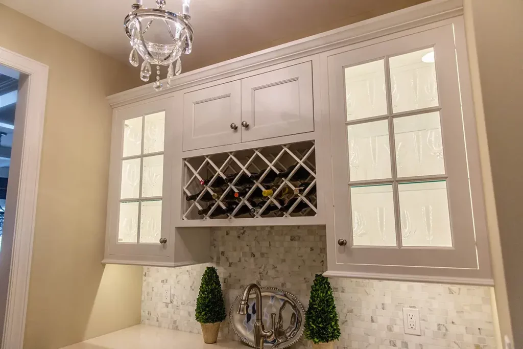 Custom white cabinet with glass inlay doors and wine rack