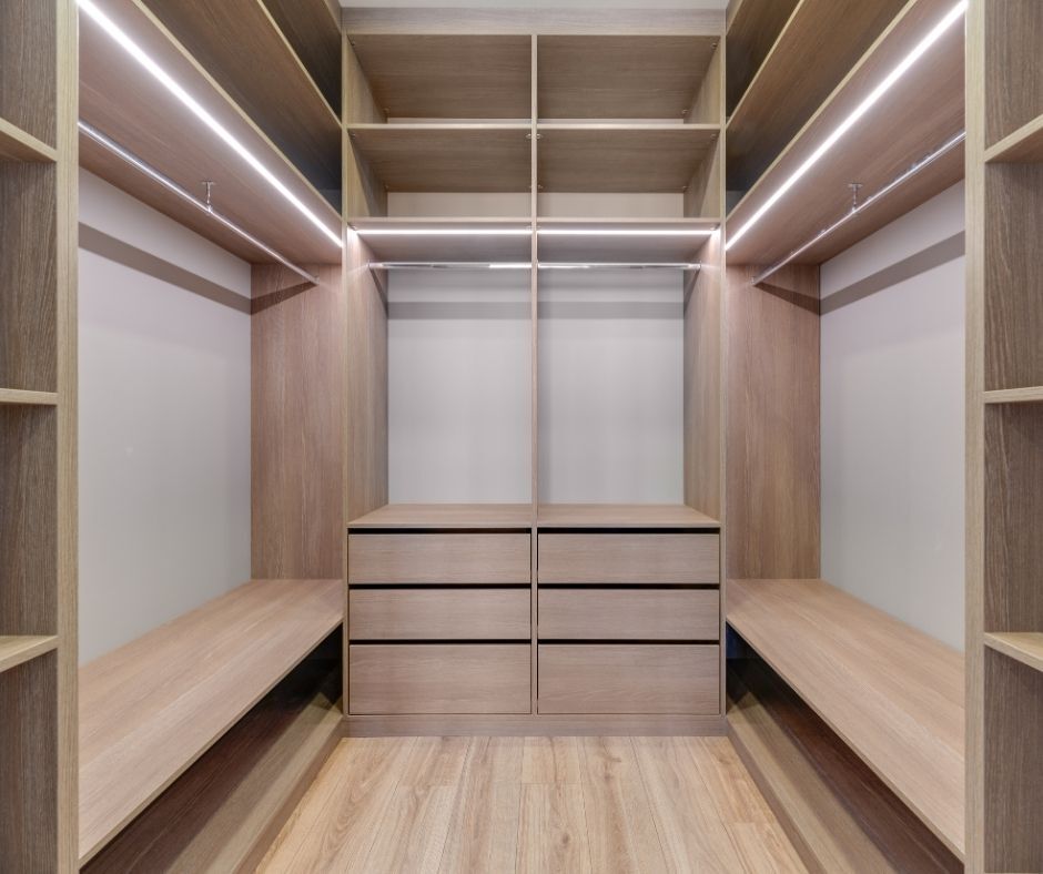 A closet with shelf lighting.