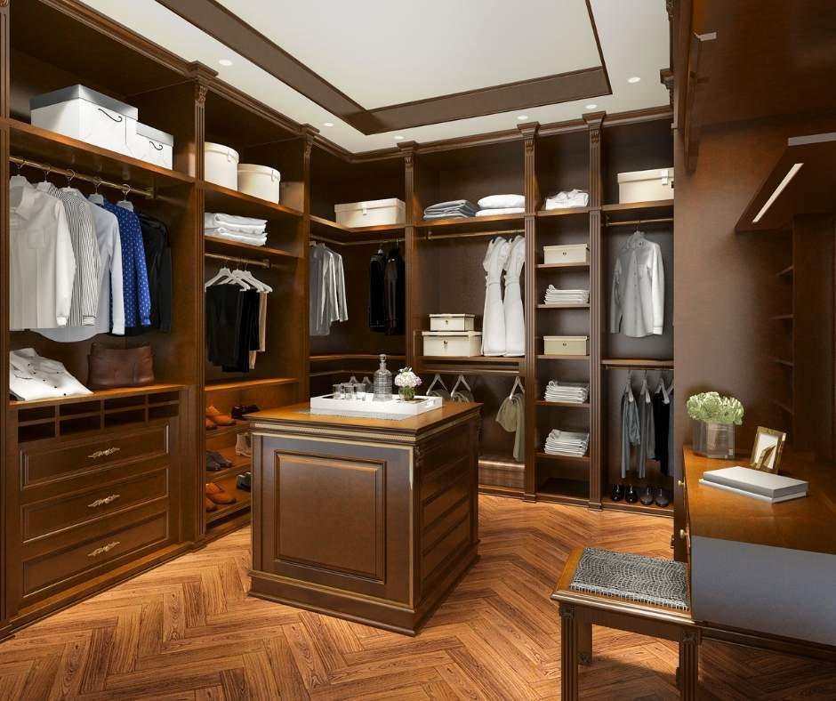 Walk-in closet with dark wood shelves and drawers.