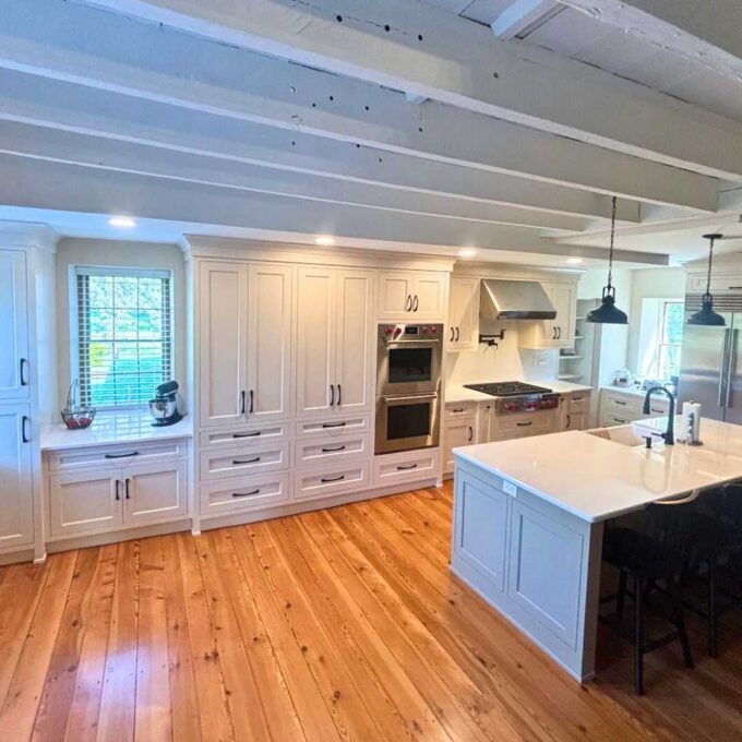 A farmhouse kitchen with wood floors and an island.