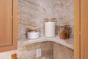 Wide tile backsplash on a pantry shelf.