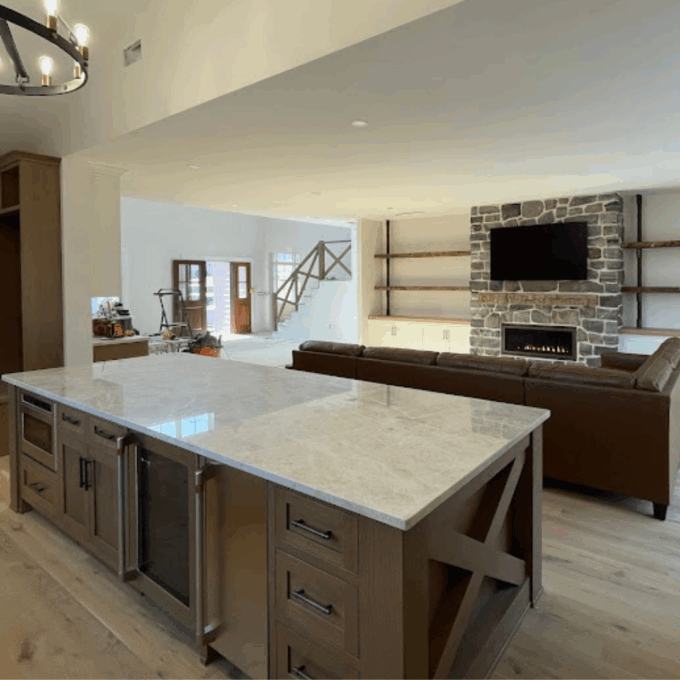 An open kitchen with a large oak island.