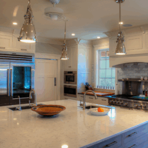 A kitchen with a large kitchen island and white counters.