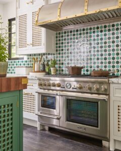 Green kitchen with stainless range.