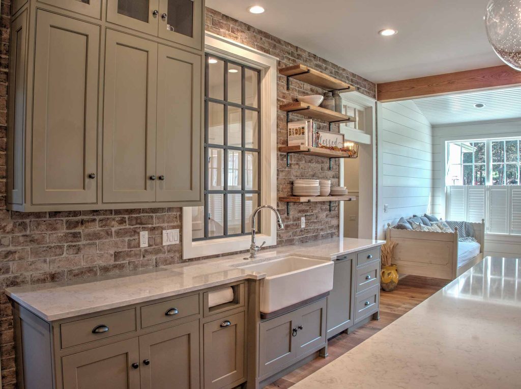 A kitchen with a sink and shelves and quartz countertops in an orefield kitchen remodel