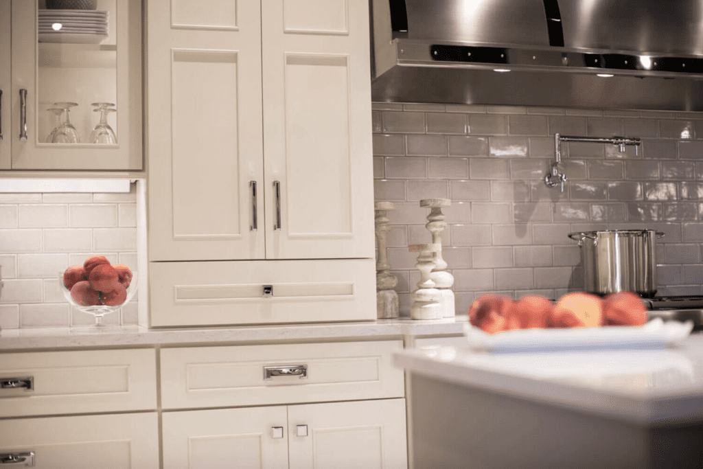 Transitional Kitchen Design with White Cabinetry and metal cooking hood
