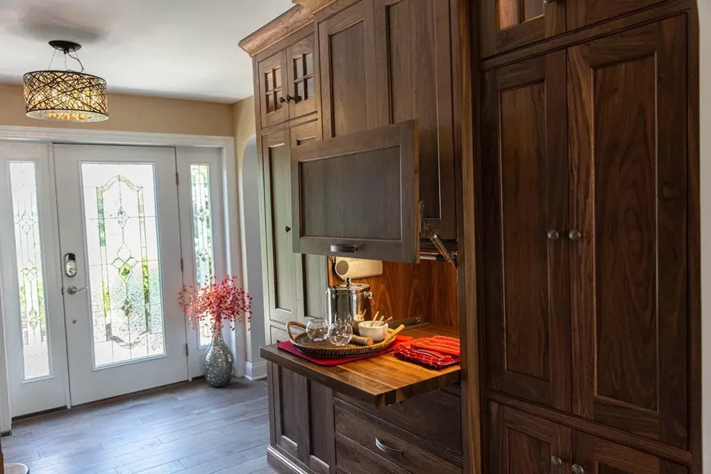 Built In Cabinets for a Functional Entryway in Easton Pennsylvania with a small bar and dark wood stain.