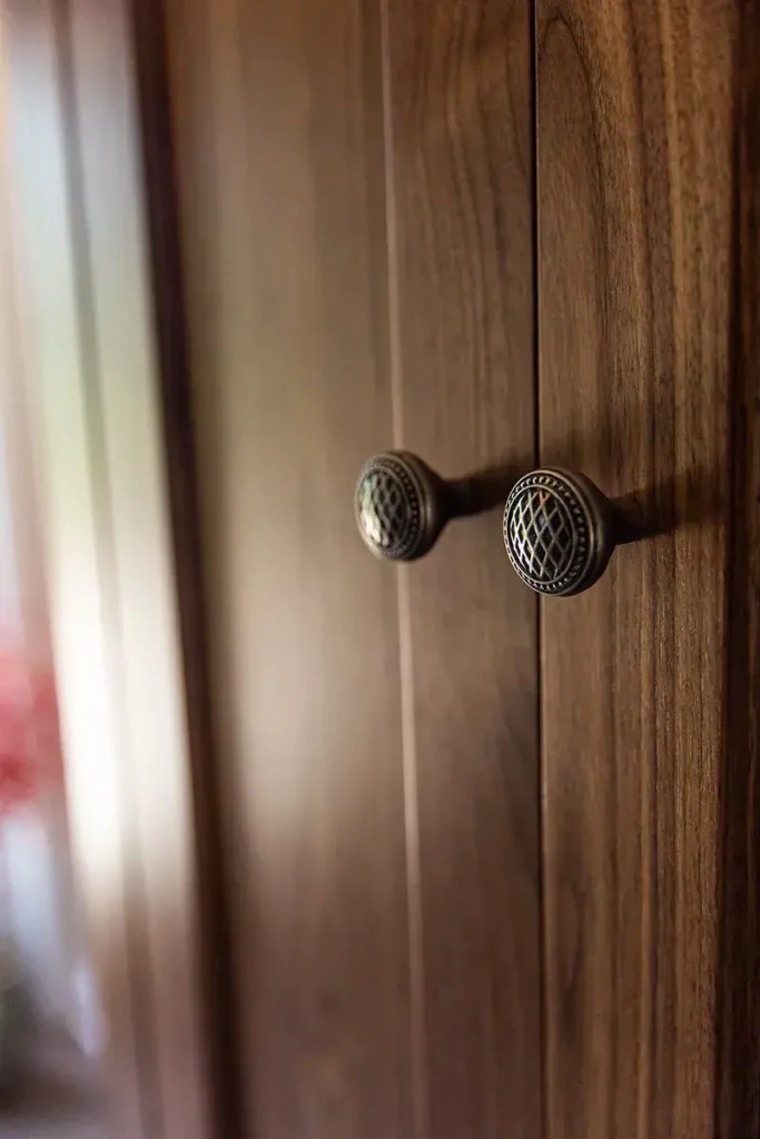 Custom cabinet door knob pulls on a dark wood stain finish