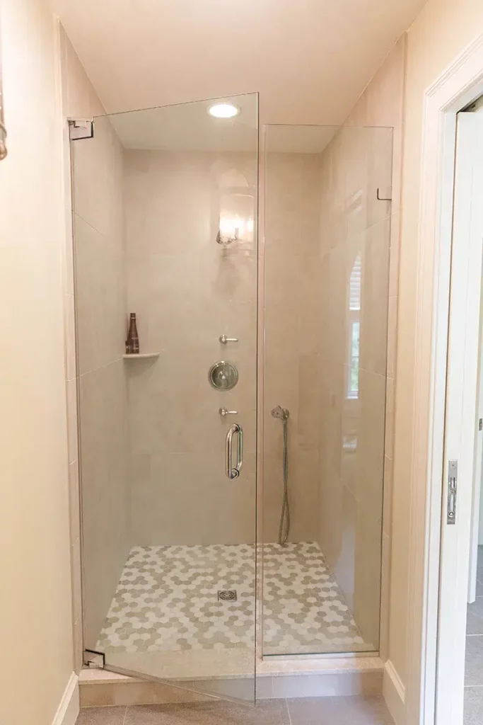 Walk-in shower with small hexagon shaped tile