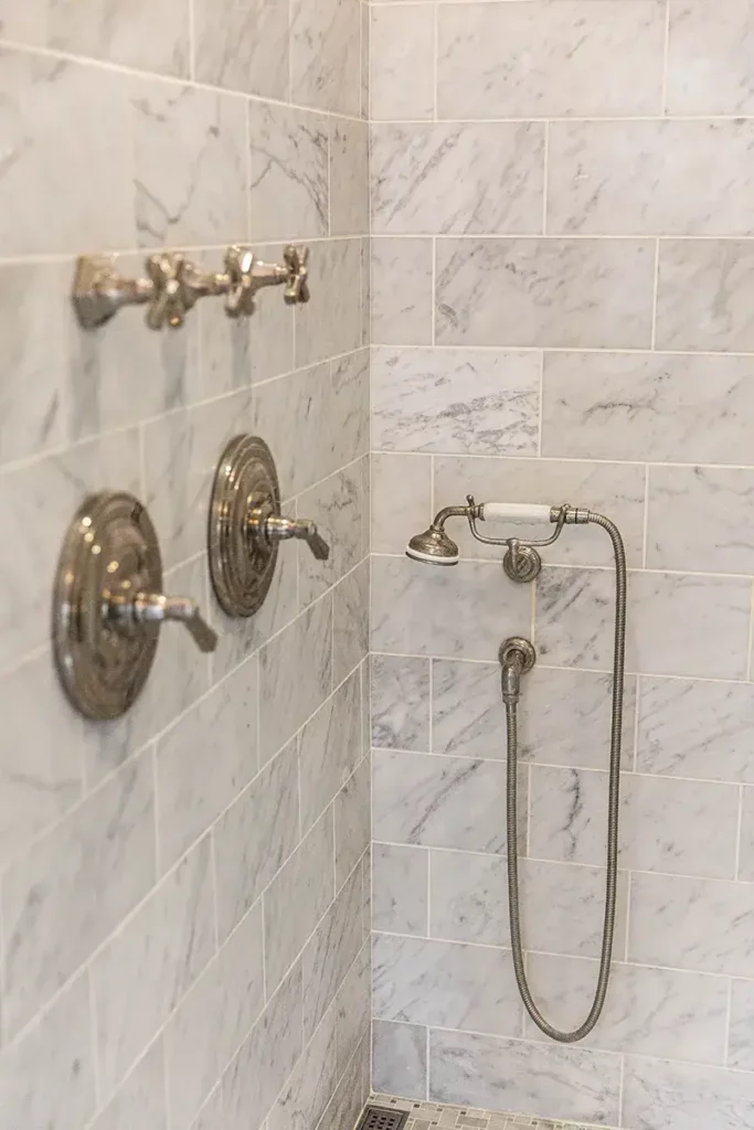 Walk-in shower with classic chrome finished shower fixtures