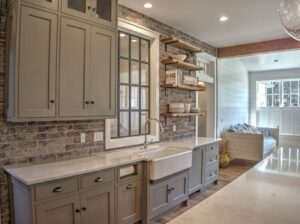kitchen with white countertops and a farm sink with green cabinetry