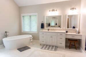 bathroom with freestanding tub and white vanity