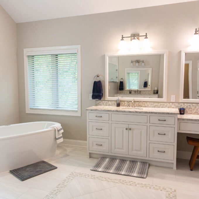 bathroom with freestanding tub and white vanity