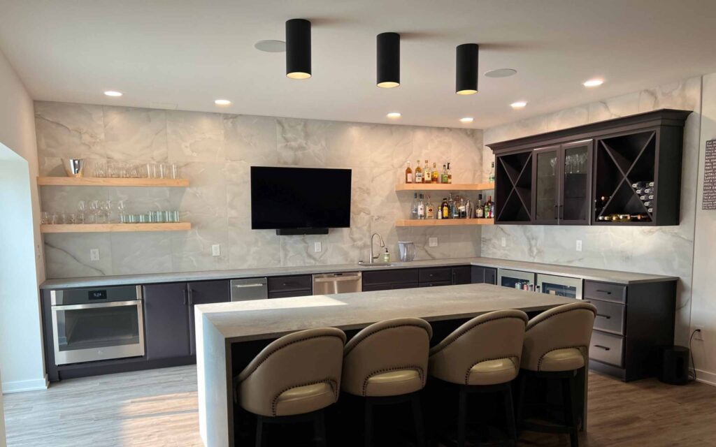 basement bar remodel in bath pa with floating shelves and a seating island for tv viewing