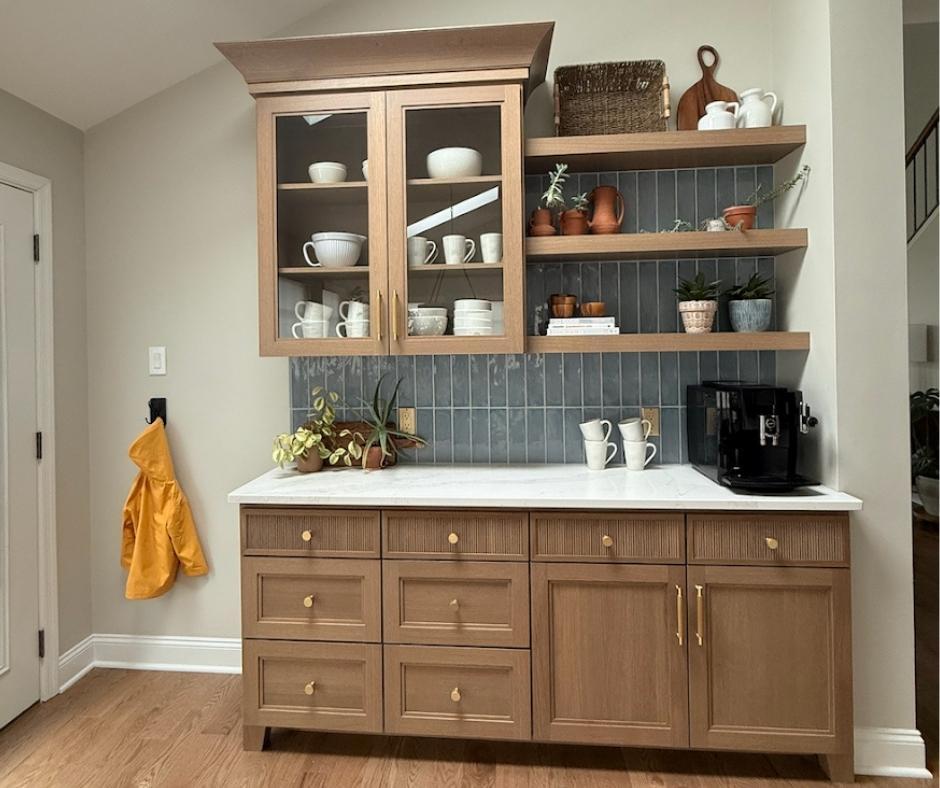 A custom coffee bar with oak reeded cabinets.