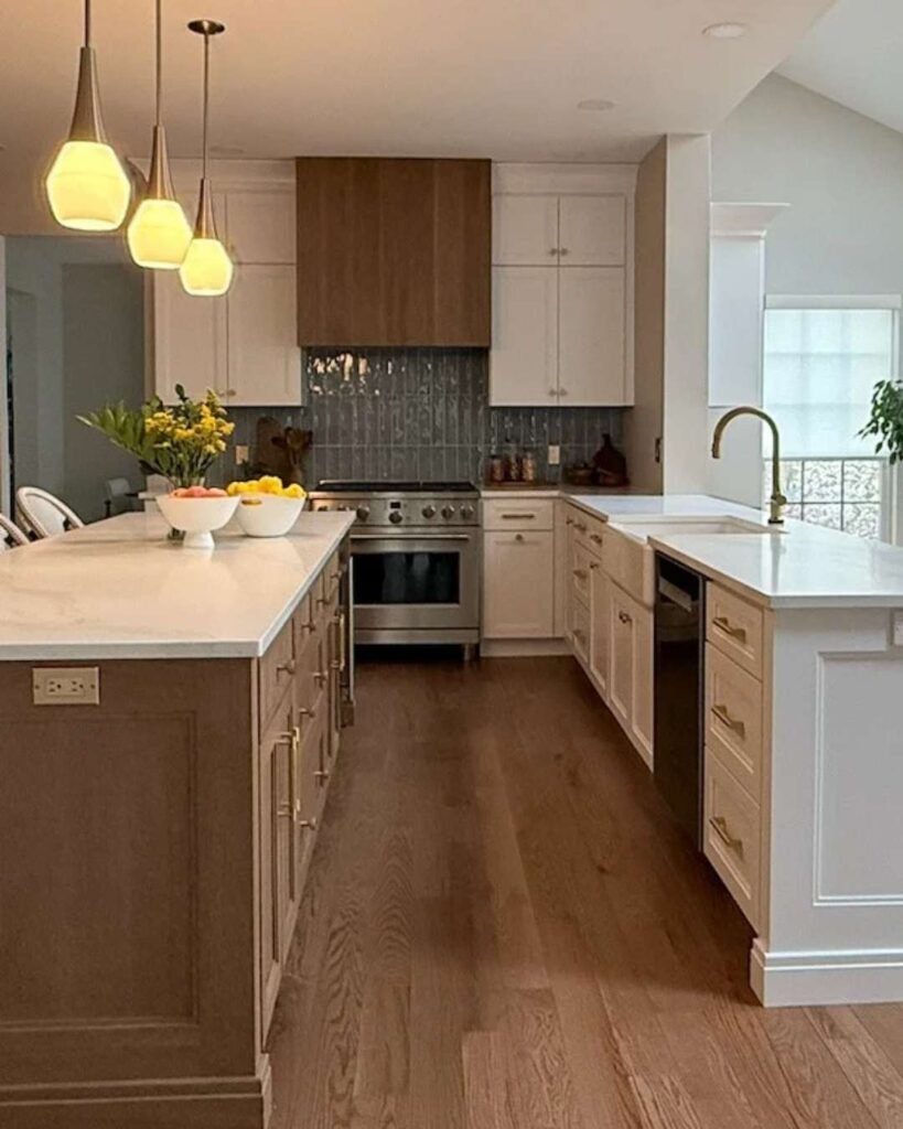 Kitchen with white and oak cabinets, as well as a large island.