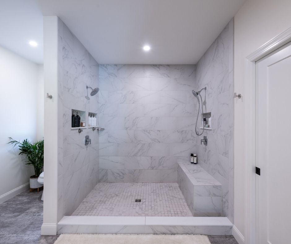 A large open gray marble tiled shower for two. Designed for a Hellertown bath remodel by Laslo Kitchens