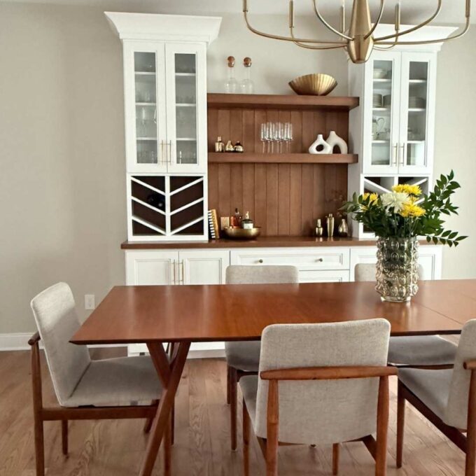 Dining room with mid-century table and white custom cabinets.