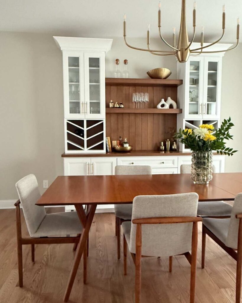 Dining room with mid-century table and white custom cabinets.