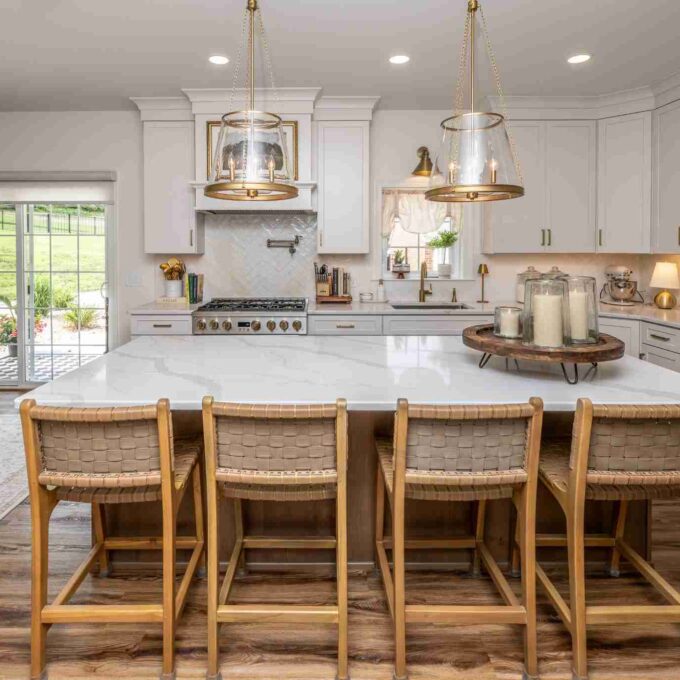 This Laslo kitchen remodel features a large island with 4 woven barstools.