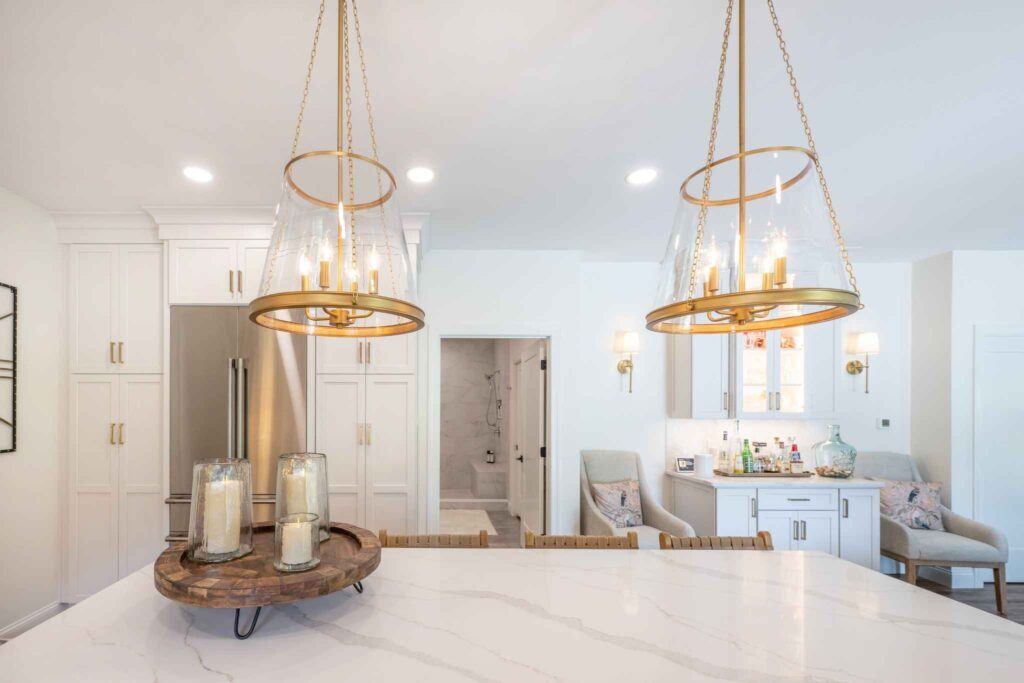 Two glass pendants over a large quartz island.
