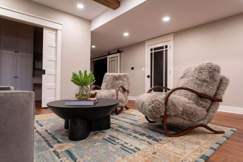 seating area with fur chairs and a black coffee table in the basement of a coopersburg home