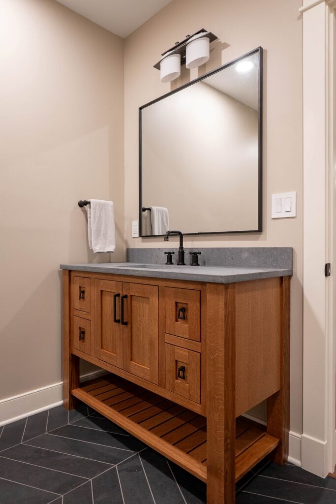 Bathroom vanity with white oak cabinetry and quartz countertop