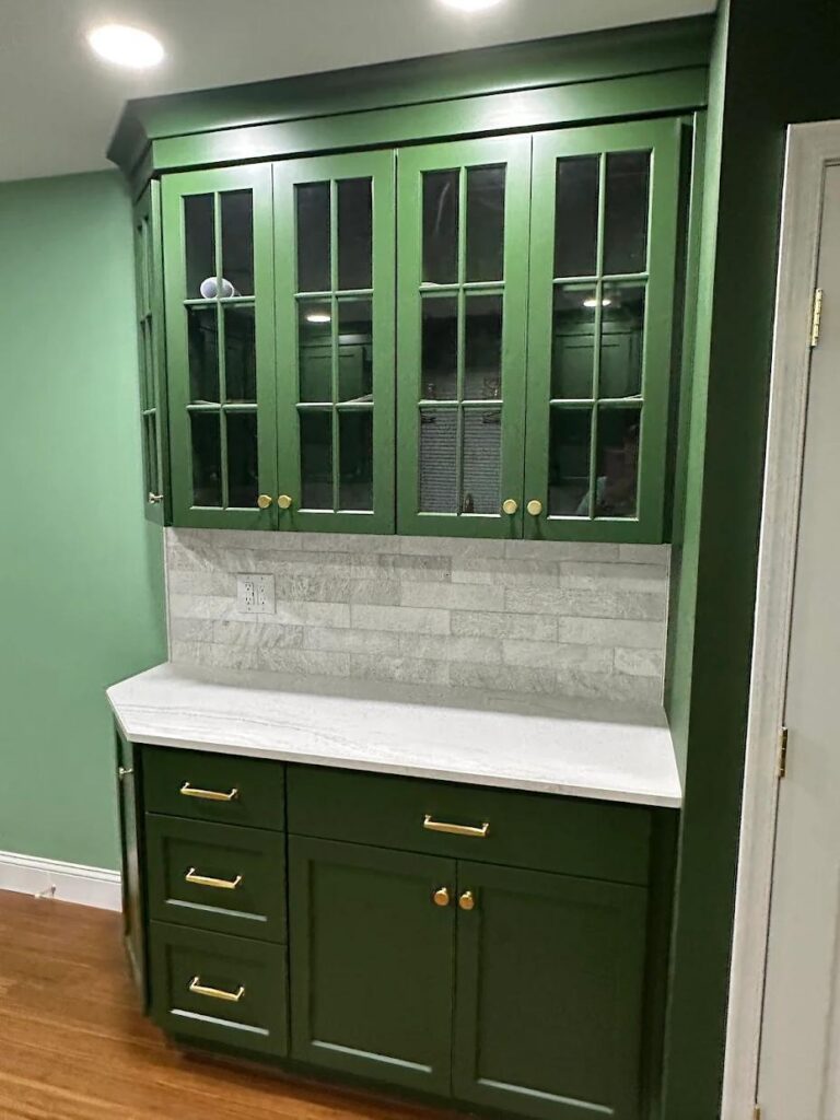 Custom cabinets in Lehigh Valley kitchen design with green finish and glass cabinet doors for display storage by Laslo Custom Kitchens