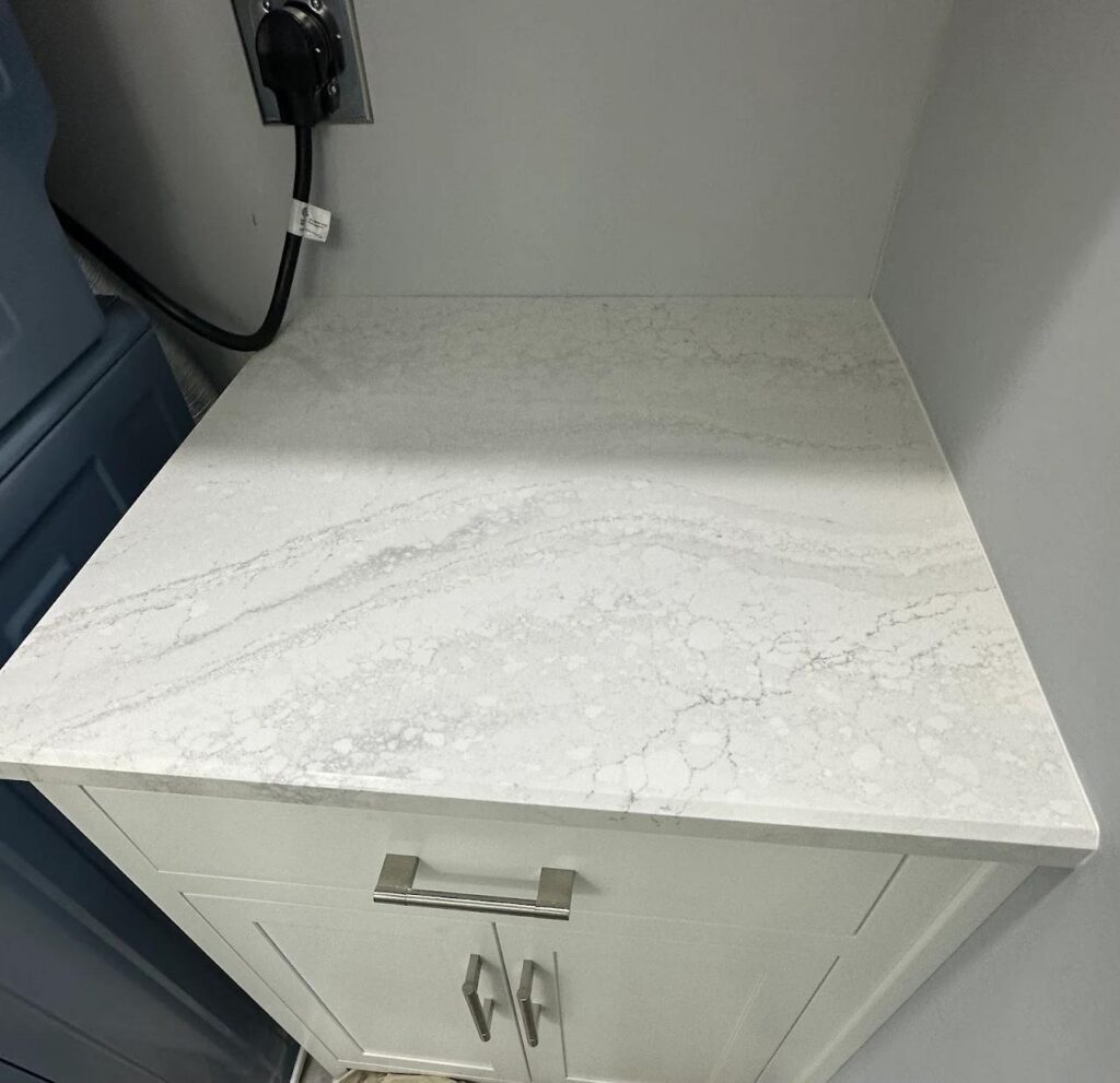 Kitchen remodel in the Lehigh Valley with Cambria Everleigh quartz countertops and green cabinetry