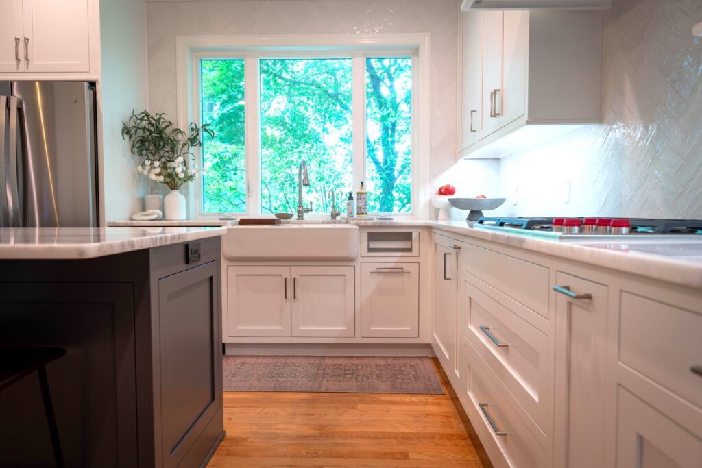farmhouse sink with a woodland view in a Custom kitchen design in Center Valley PA with flush inset custom cabinets and tailored layout