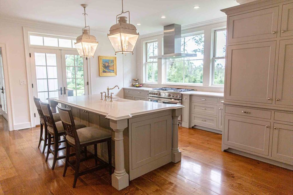 A kitchen with a island and chairs