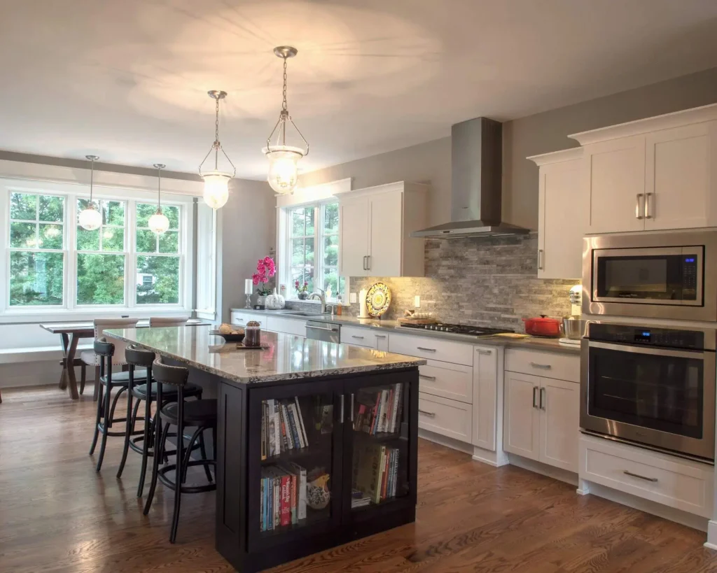 A kitchen with a large island and a large window