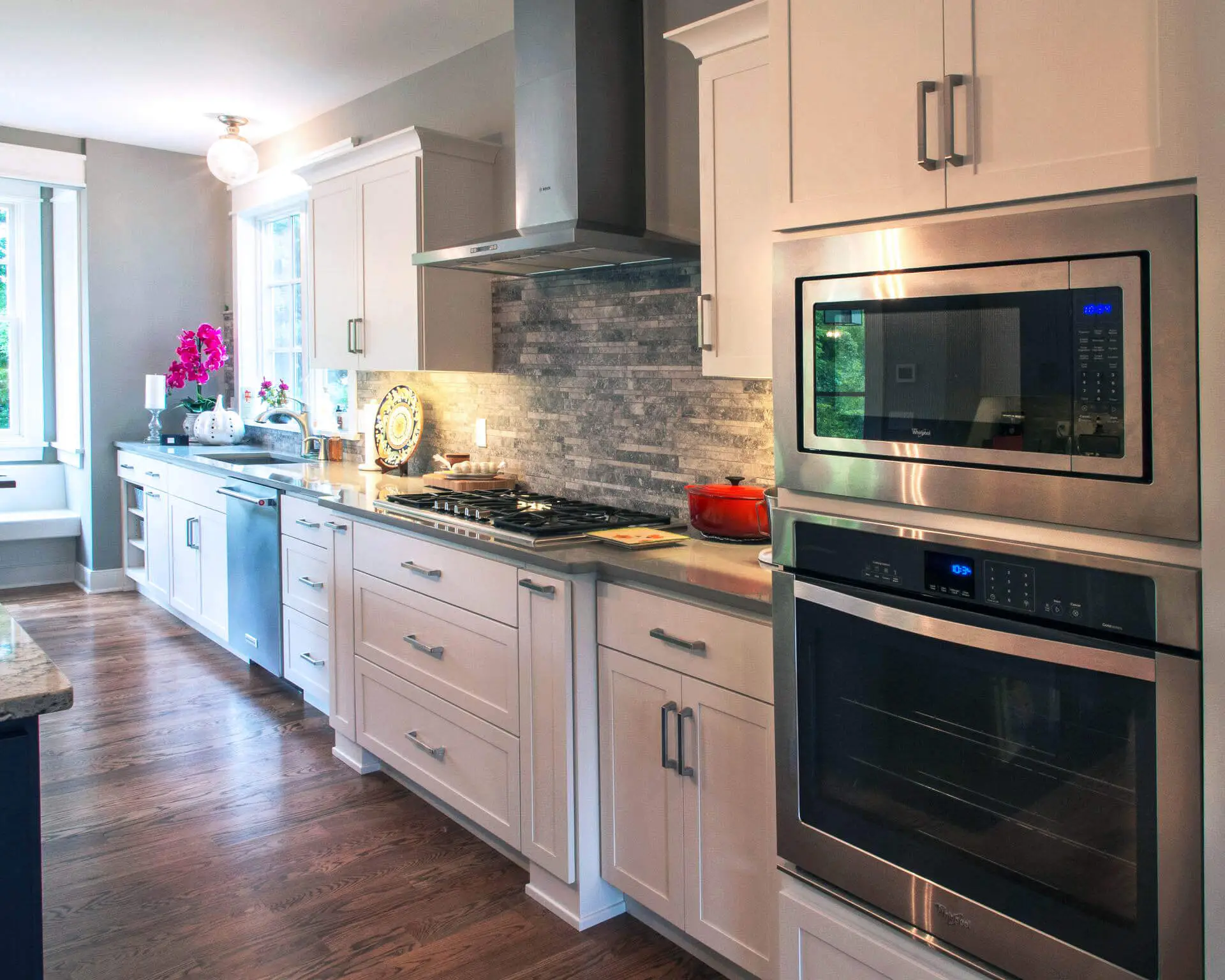 A kitchen with white cabinets and stainless steel appliances