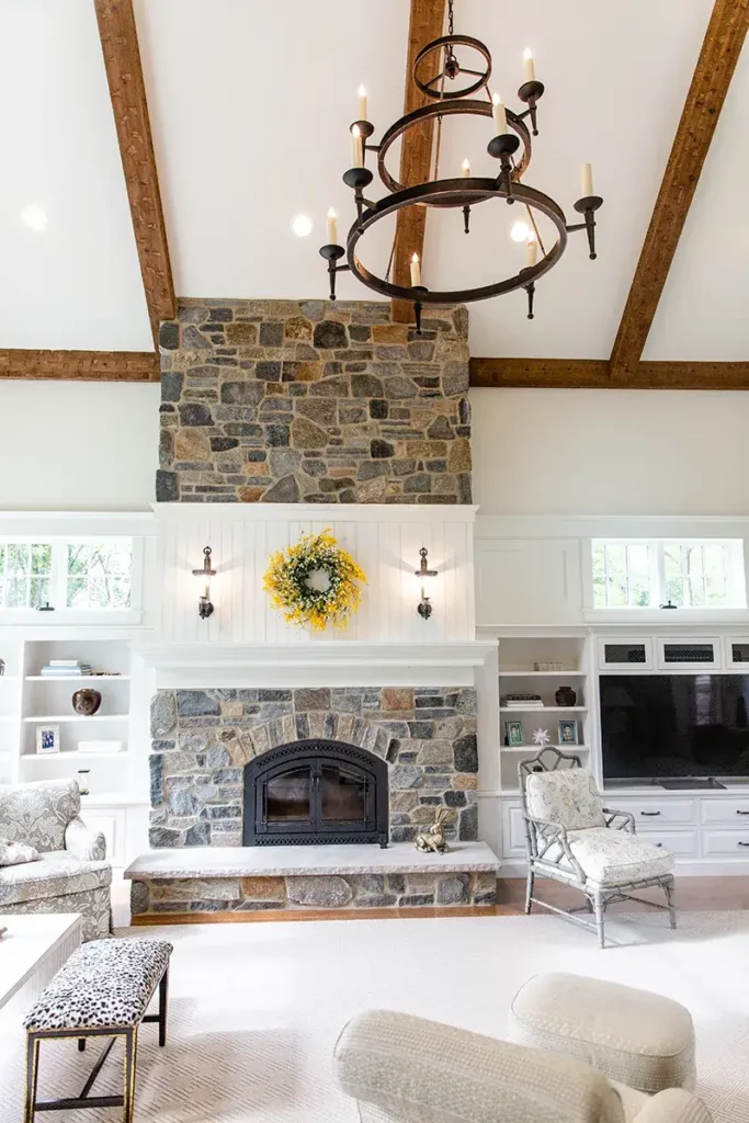 Custom fireplace that is constructed using stones and stones that are shaped like bricks. As well as custom cabinetry that flanks the fireplace.