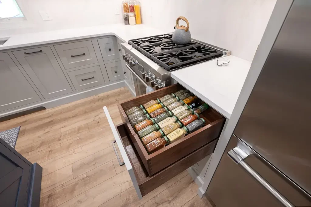 custom cabinetry organization solutions that incorporate spice drawers and other organization aspects to help maintain a functional kitchen