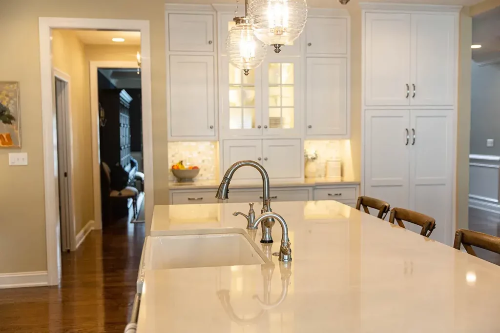 Custom kitchen cabinets with farmhouse sink and brushed nickel kitchen faucet.