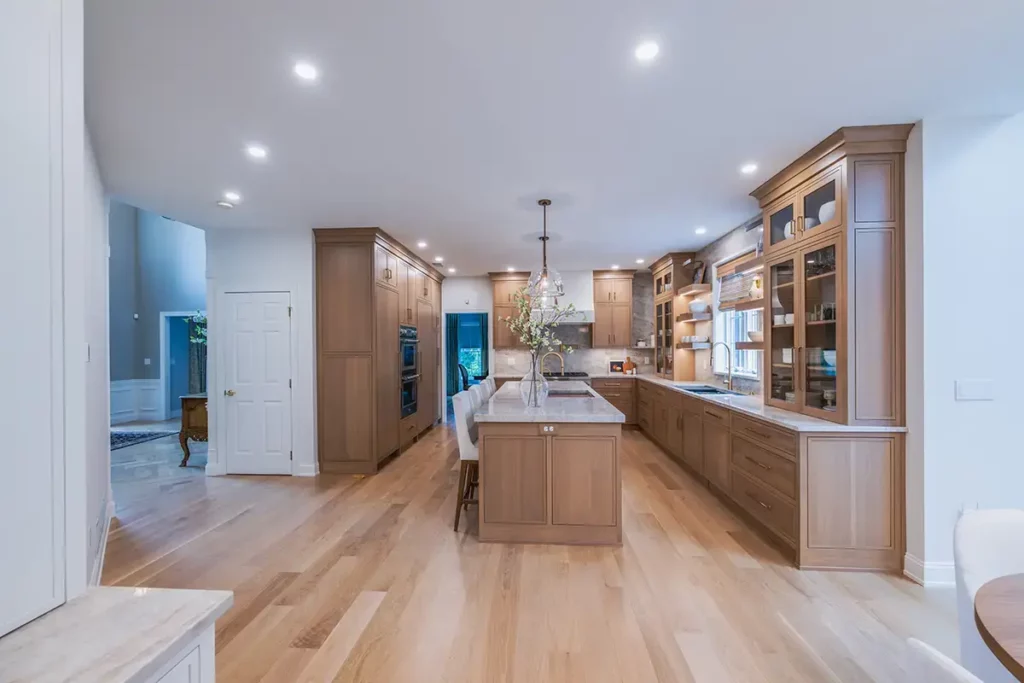 sesame stained cabinets in this kosher kitchen remodel are the white oak floors.