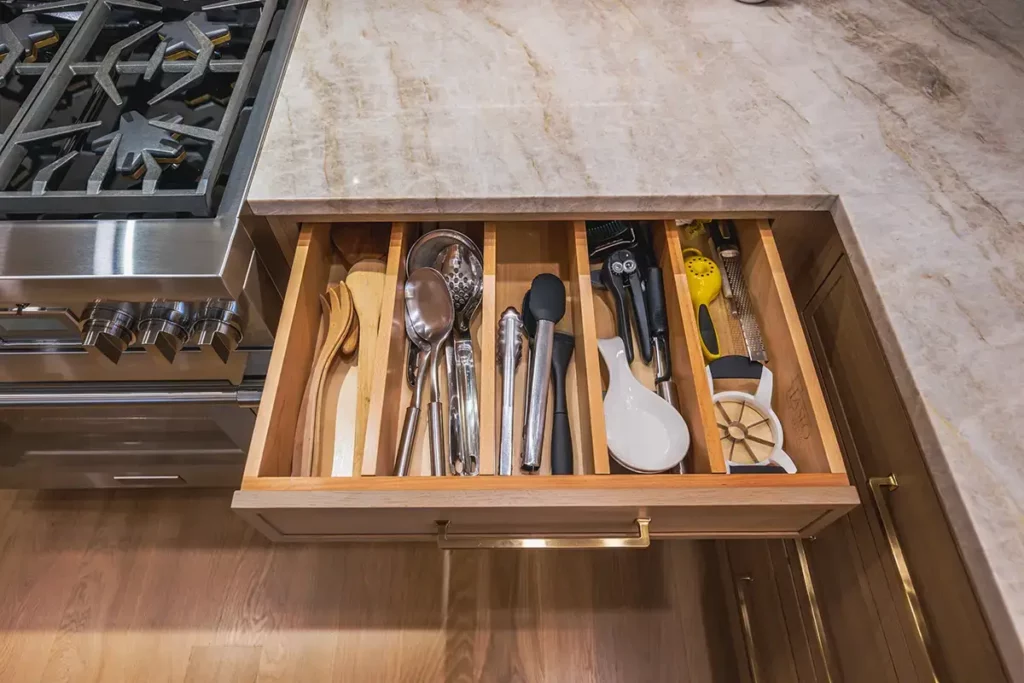 flatware organizer built into kitchen cabinet drawer.