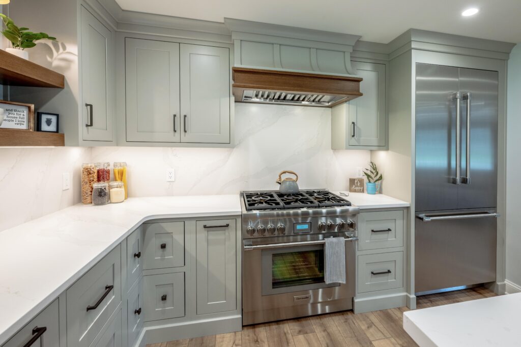 kitchen with  mint green cabinetry and white countertops