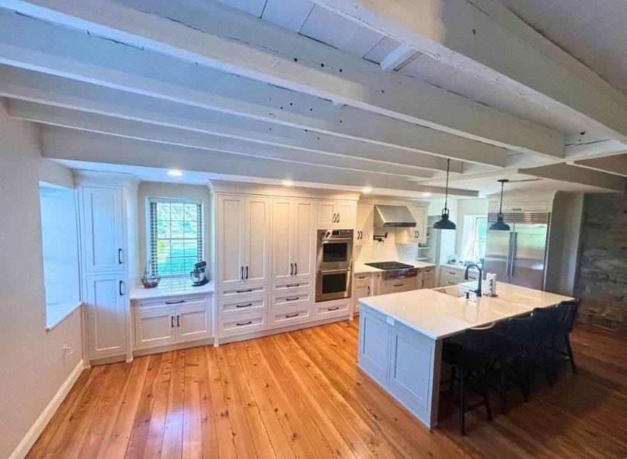 A farmhouse kitchen with wood floors and an island.