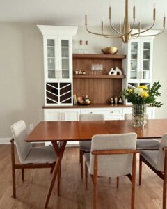 Dining room with mid-century table and white custom cabinets.
