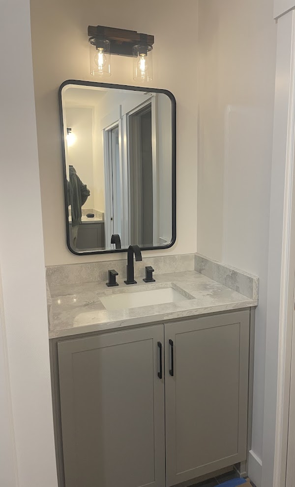 A bathroom with a gray cabinet.