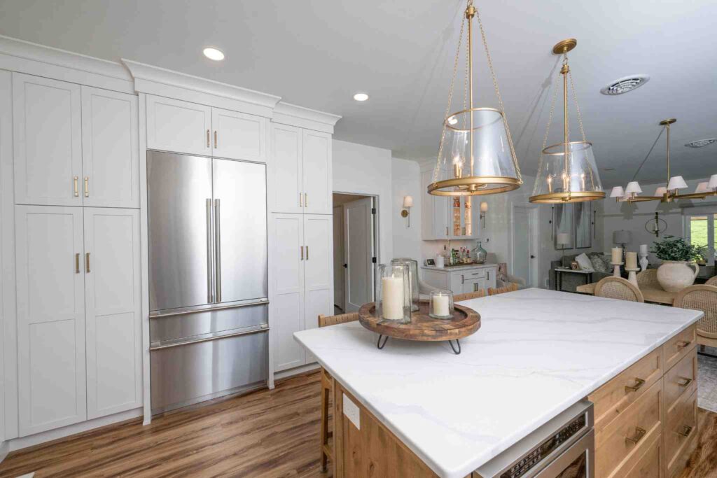A kitchen with a large alder island and White Linen painted cabinets.