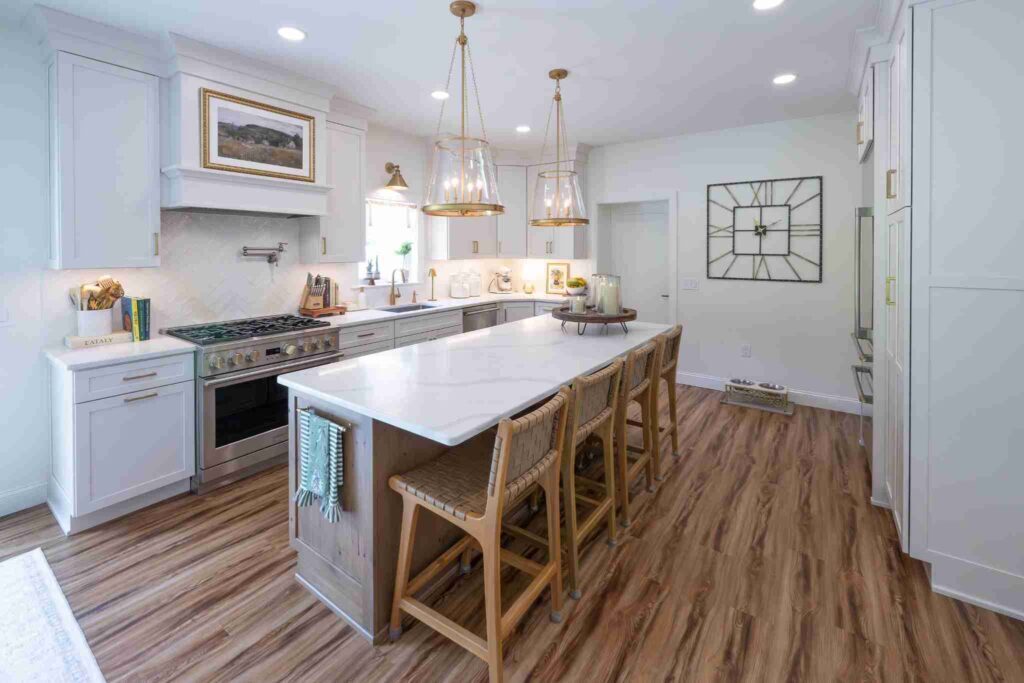 A kitchen with a large island, wood floors and maple cabinets.