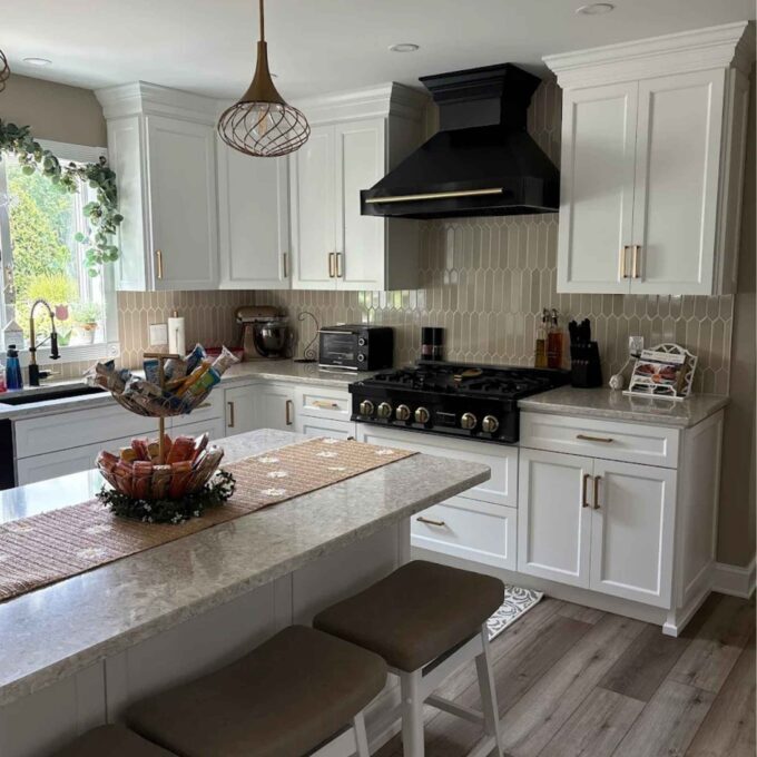 A black range and white cabinets in Easton kitchen.