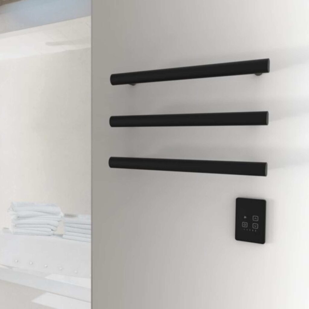 Smart towel warmer on wall in black.