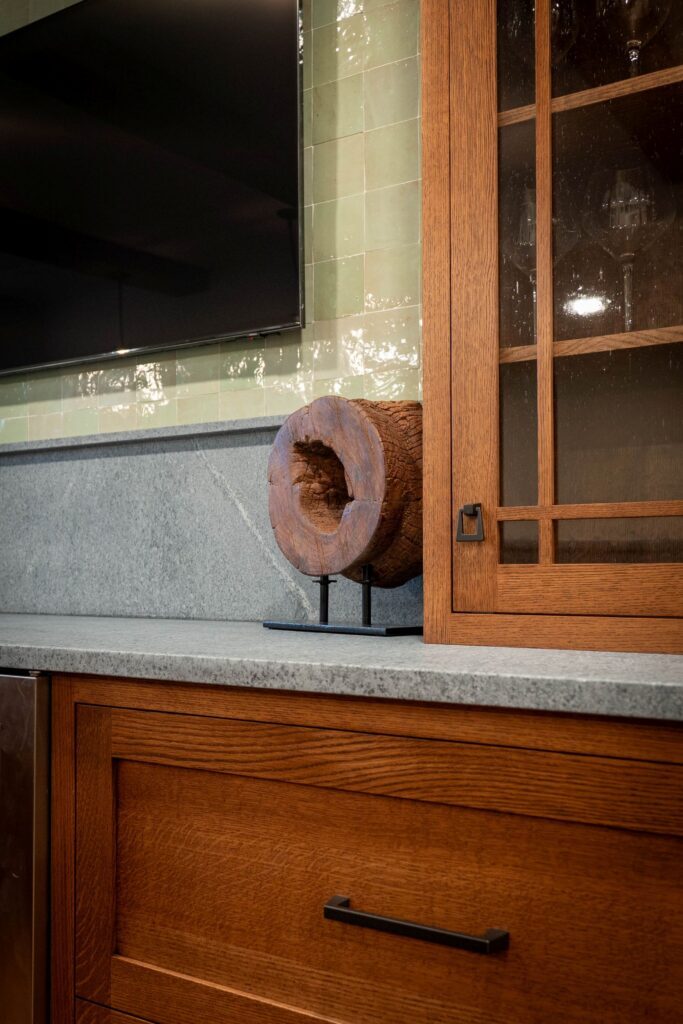 Quarter sawn white oak basement cabinetry with seeded glass doors and soapstone countertop