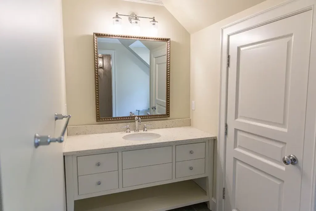 Custom bathroom vanity in large mirror and nickel plated light fixture