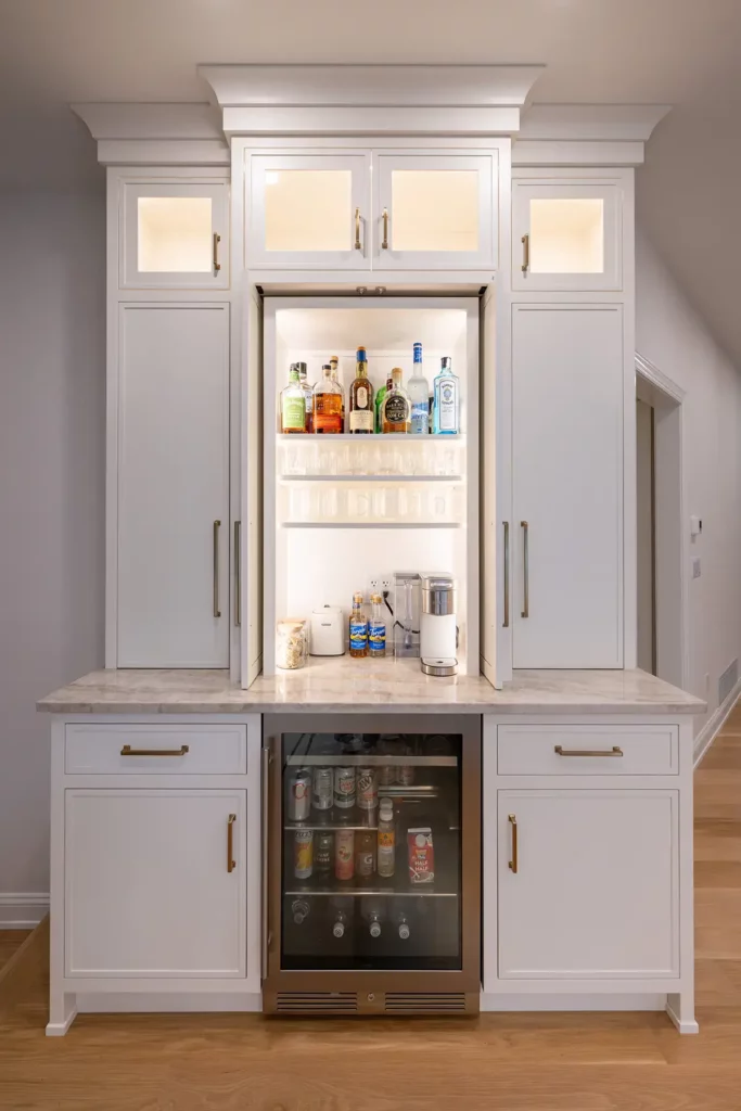 A wet bar by Laslo Custom Kitchens with a beverage cooler.