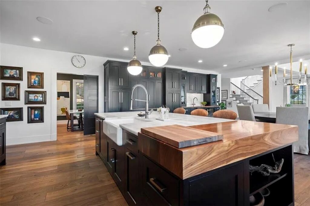 A sophisticated open-concept design made possible by a zero percent financing kitchen remodel, highlighting beautiful butcher block countertops seamlessly integrated with rich, furniture-grade custom cabinetry finishes.